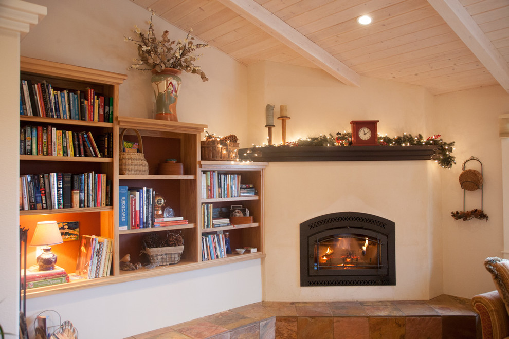 Inspiration for a medium sized rural enclosed games room in Sacramento with a reading nook, white walls, a corner fireplace, a plastered fireplace surround and no tv.