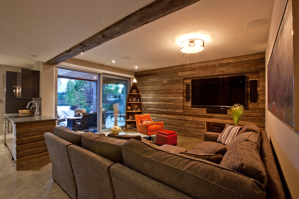 Inspiration for a contemporary concrete floor family room remodel in Vancouver with multicolored walls and a media wall