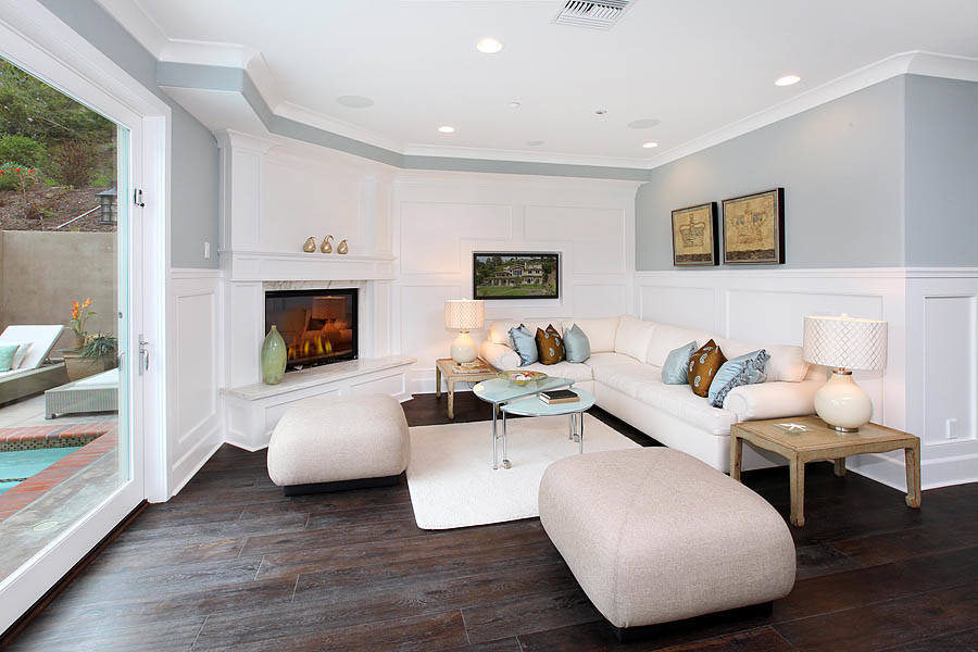 Small elegant enclosed dark wood floor and brown floor family room photo in Orange County with gray walls, a standard fireplace and a tile fireplace