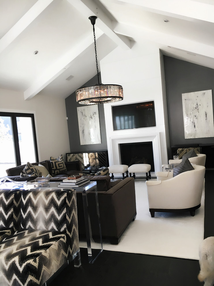Inspiration for a medium sized contemporary open plan games room in Other with white walls, dark hardwood flooring, a standard fireplace, a plastered fireplace surround and a built-in media unit.