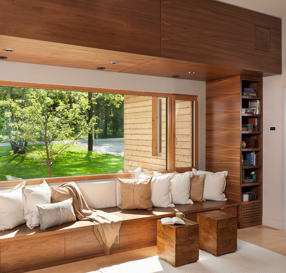 Inspiration pour une salle de séjour design ouverte avec une bibliothèque ou un coin lecture, un mur blanc et parquet clair.
