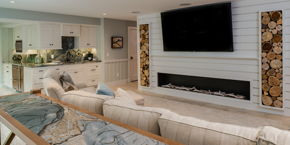 На фото: большая открытая гостиная комната в морском стиле с домашним баром, белыми стенами, горизонтальным камином, фасадом камина из дерева, телевизором на стене, бежевым полом и светлым паркетным полом