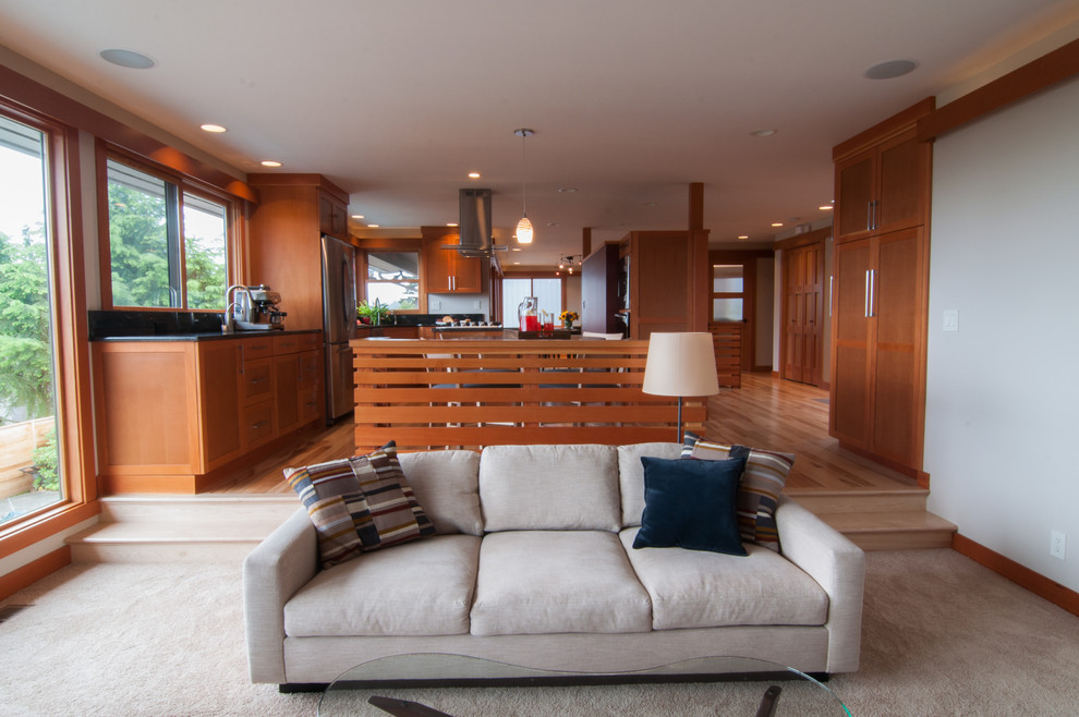 This is an example of a contemporary open plan games room in Seattle with carpet.