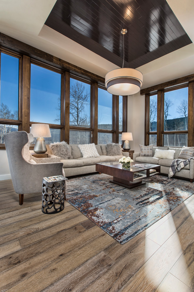 Design ideas for an expansive traditional open plan games room in Denver with beige walls, light hardwood flooring, a standard fireplace, a stone fireplace surround and brown floors.