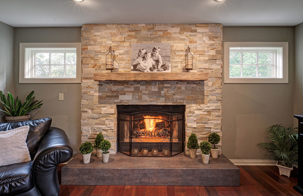 Inspiration for a large transitional medium tone wood floor and red floor family room remodel in Milwaukee with green walls, a standard fireplace and a brick fireplace