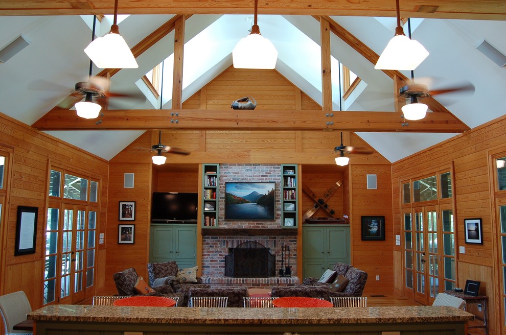 Mid-sized arts and crafts open concept light wood floor and beige floor family room photo in Houston with brown walls, a standard fireplace, a brick fireplace and a tv stand