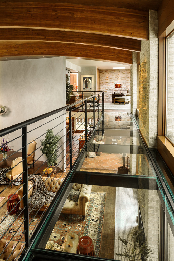 Photo of an expansive eclectic enclosed games room in Milwaukee with grey walls, terracotta flooring, a standard fireplace and no tv.