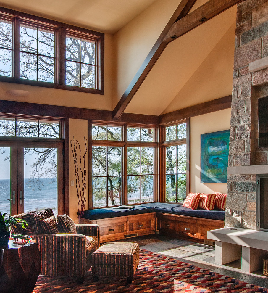 Mountain style family room photo in Milwaukee with a stone fireplace