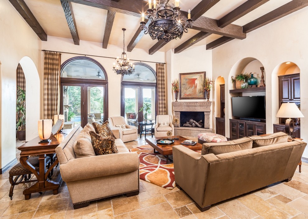 Design ideas for a large mediterranean open plan games room in Houston with beige walls, a corner fireplace, beige floors, travertine flooring and a freestanding tv.
