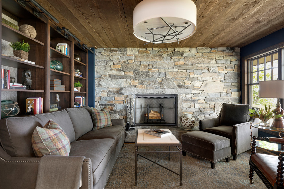 Design ideas for a medium sized coastal enclosed games room in Minneapolis with a reading nook, a standard fireplace, grey walls, carpet, a stacked stone fireplace surround, no tv, brown floors, a wood ceiling, wood walls and a feature wall.