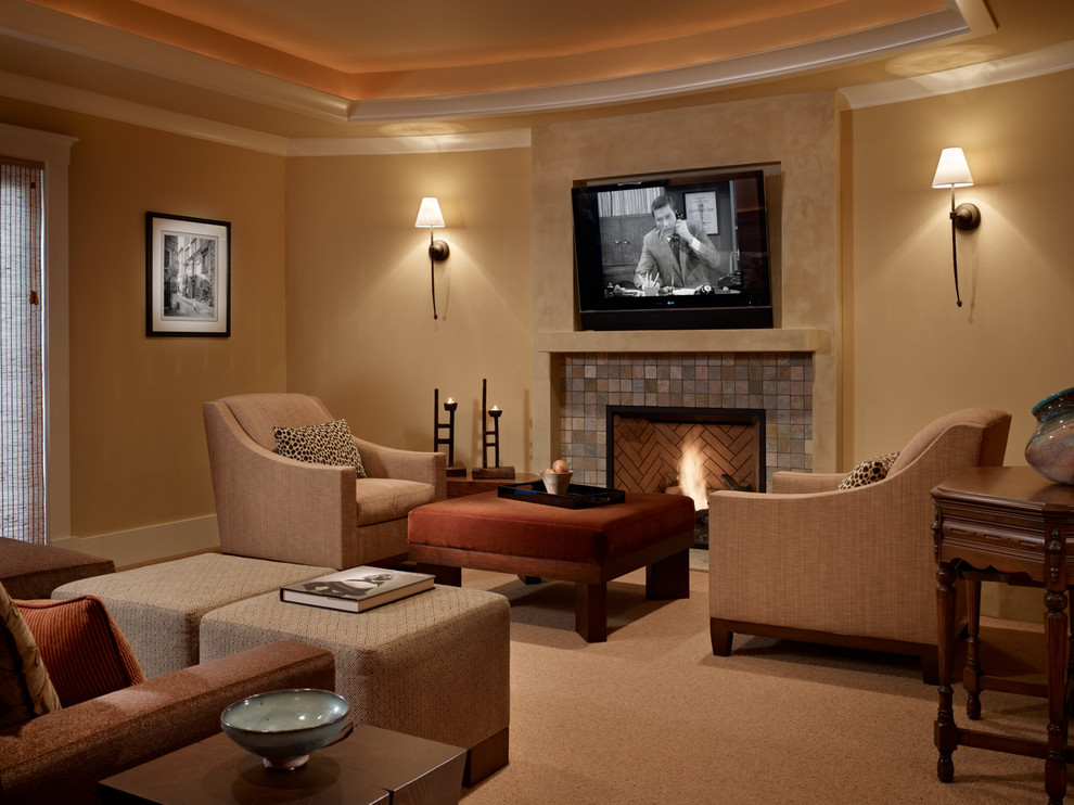 This is an example of a medium sized mediterranean open plan games room in Seattle with beige walls, carpet, a standard fireplace, a wall mounted tv and a tiled fireplace surround.