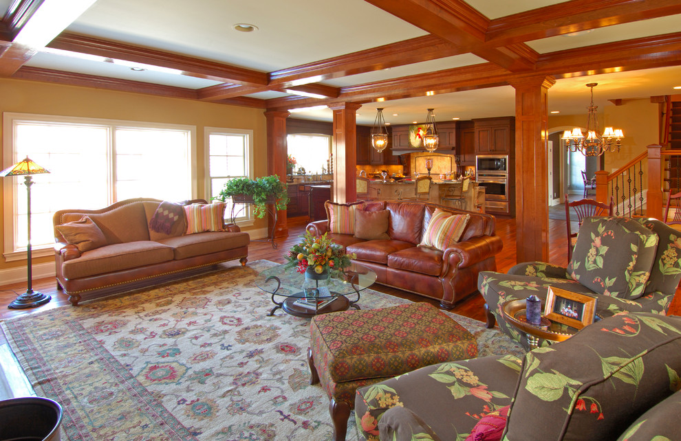 Cette image montre une grande salle de séjour traditionnelle ouverte avec un mur beige, un sol en bois brun, aucune cheminée et aucun téléviseur.
