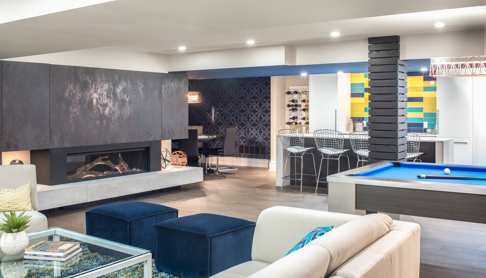 This is an example of a large contemporary open plan games room in Toronto with white walls, medium hardwood flooring, a standard fireplace and a concrete fireplace surround.