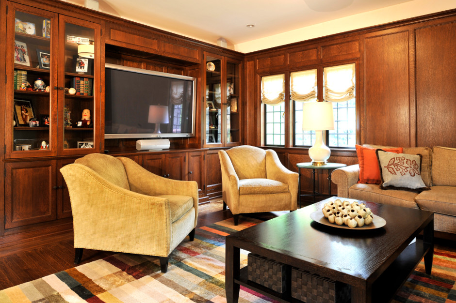 Example of a classic enclosed dark wood floor family room design in New York with brown walls and a media wall