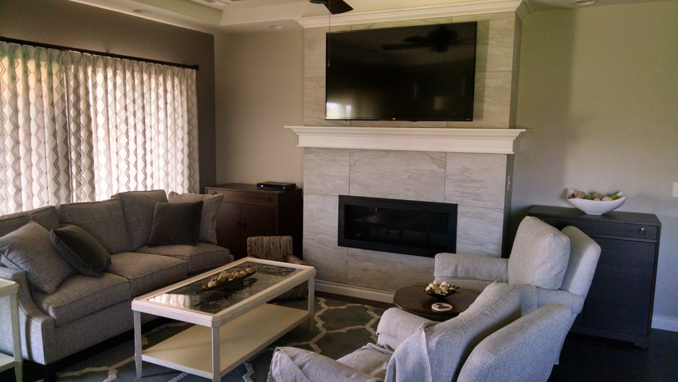 This is an example of a small contemporary enclosed games room in Denver with grey walls, a ribbon fireplace, a tiled fireplace surround, a wall mounted tv, dark hardwood flooring and brown floors.
