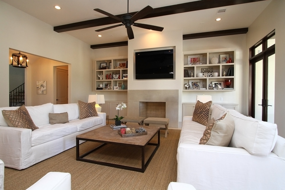 Inspiration for a large traditional open plan games room in Houston with a standard fireplace, a stone fireplace surround, a wall mounted tv, beige walls, ceramic flooring and beige floors.