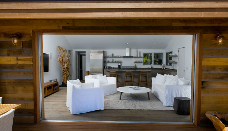 Inspiration for a mid-sized contemporary enclosed light wood floor and gray floor family room remodel in Los Angeles with white walls, no fireplace and a wall-mounted tv