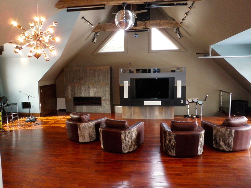 This is an example of a large contemporary enclosed games room in Toronto with a music area, brown walls, dark hardwood flooring, a ribbon fireplace, a stone fireplace surround, a freestanding tv and brown floors.