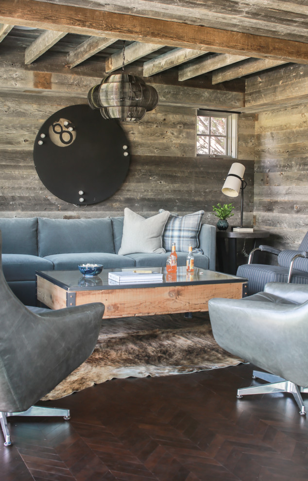 Mountain style brown floor family room photo in Other with gray walls