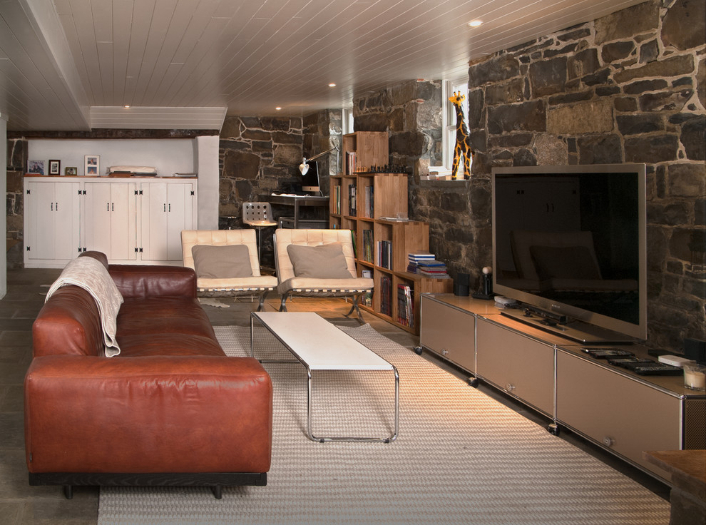 Immagine di un grande soggiorno moderno con pavimento in ardesia