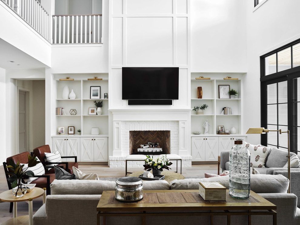 Large cottage open concept light wood floor and beige floor family room photo in Phoenix with white walls, a standard fireplace, a brick fireplace and a wall-mounted tv