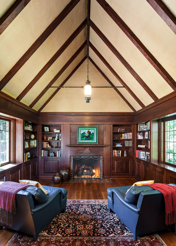 Elegant dark wood floor family room photo in Portland with a standard fireplace and a brick fireplace