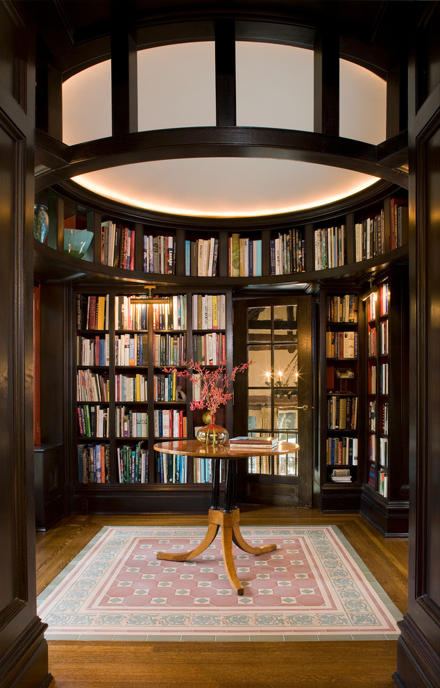 Large elegant enclosed dark wood floor and brown floor family room library photo in New York