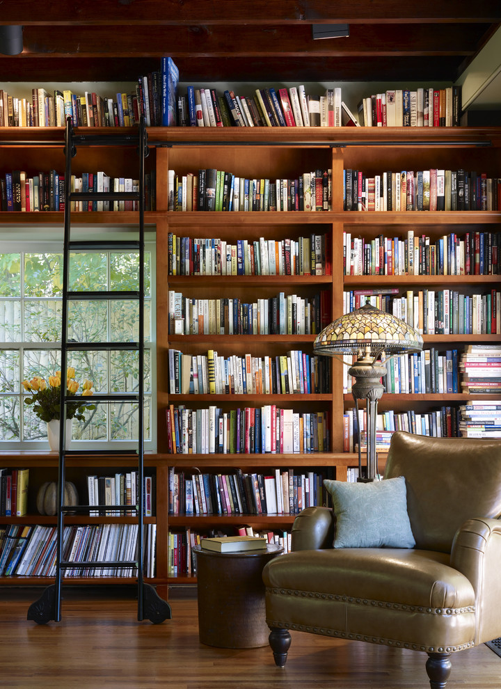 Inspiration for a craftsman medium tone wood floor family room library remodel in Philadelphia