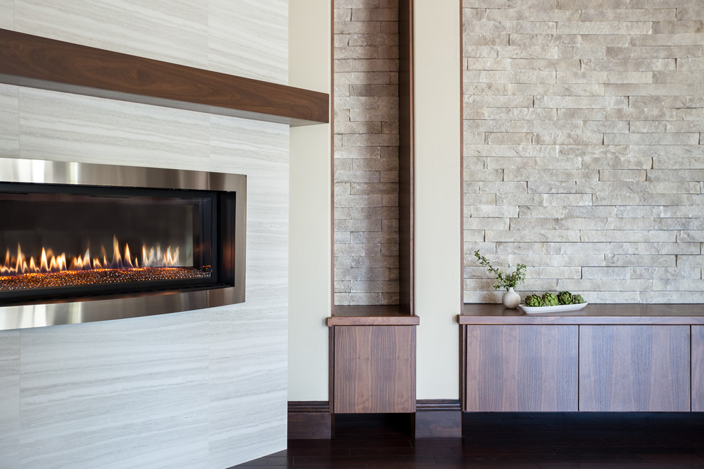 Inspiration for a mediterranean open plan games room in Sacramento with white walls, dark hardwood flooring, a standard fireplace and a tiled fireplace surround.