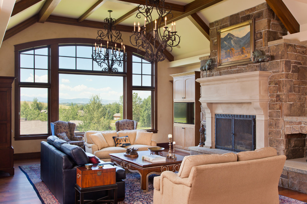 Foto de sala de estar rural con todas las chimeneas y pared multimedia