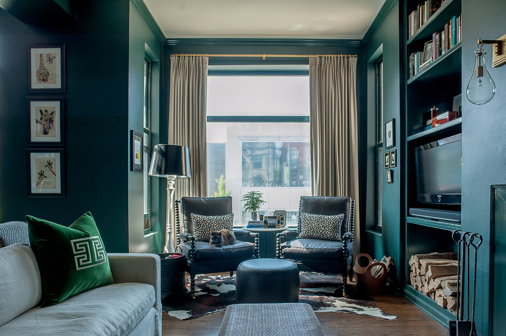 Modelo de sala de estar tradicional con paredes verdes, todas las chimeneas, pared multimedia, suelo marrón y suelo de madera en tonos medios