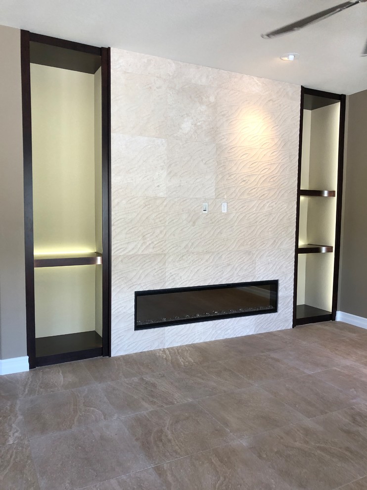 Photo of a large modern open plan games room in Las Vegas with beige walls, travertine flooring, a ribbon fireplace, a stone fireplace surround and beige floors.