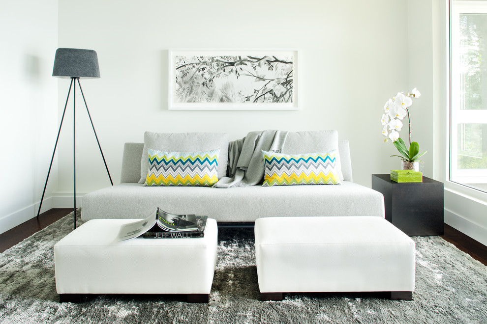 Example of a trendy brown floor family room design in Vancouver with white walls