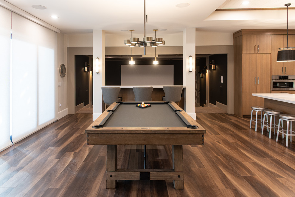 Large contemporary open plan games room in Salt Lake City with a game room, beige walls, dark hardwood flooring, no fireplace, a wall mounted tv and brown floors.