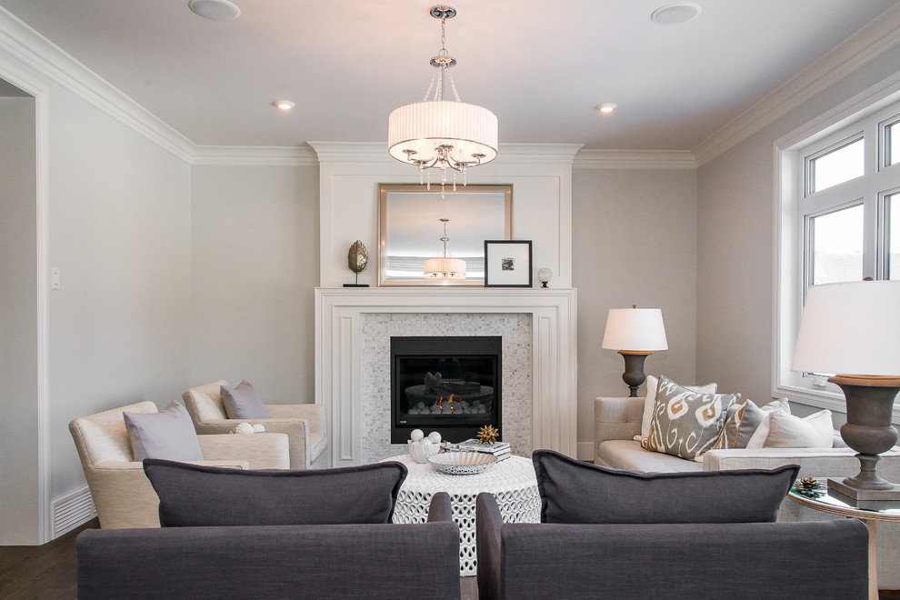 Trendy enclosed family room photo in Other with gray walls, a standard fireplace and a tile fireplace