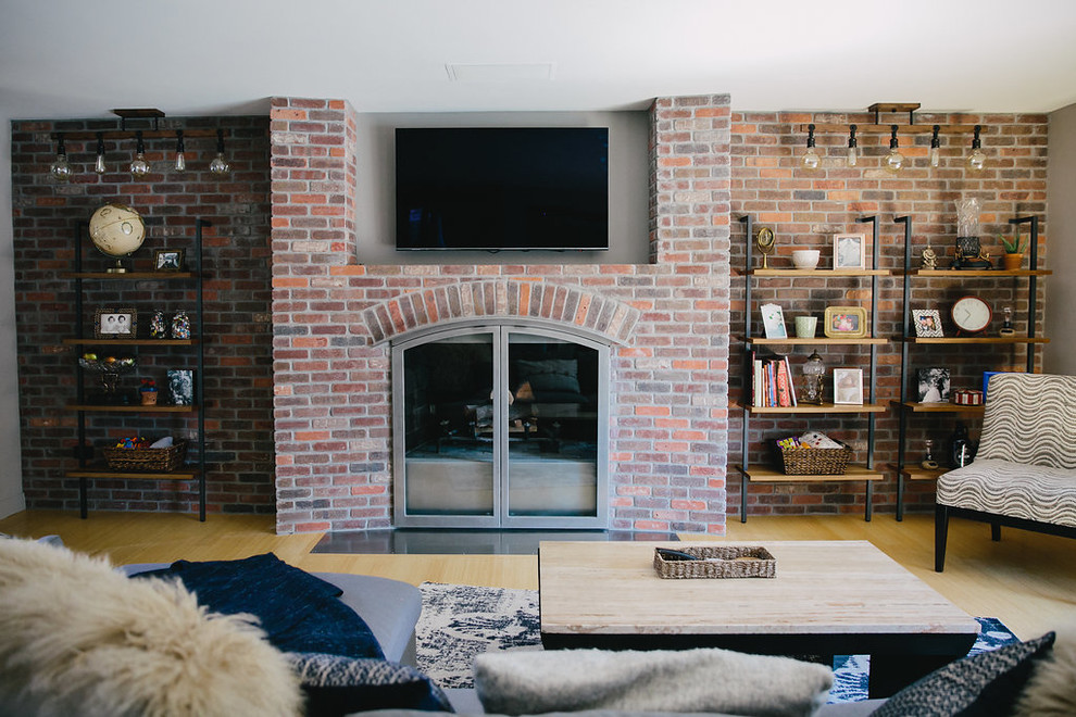 Design ideas for a large contemporary enclosed games room in Other with a wall mounted tv, white walls, light hardwood flooring, a standard fireplace, a brick fireplace surround and beige floors.