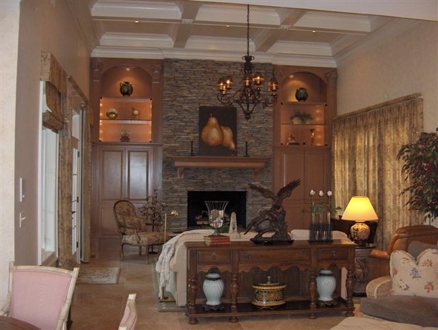 Example of a classic family room design in Raleigh with a stone fireplace