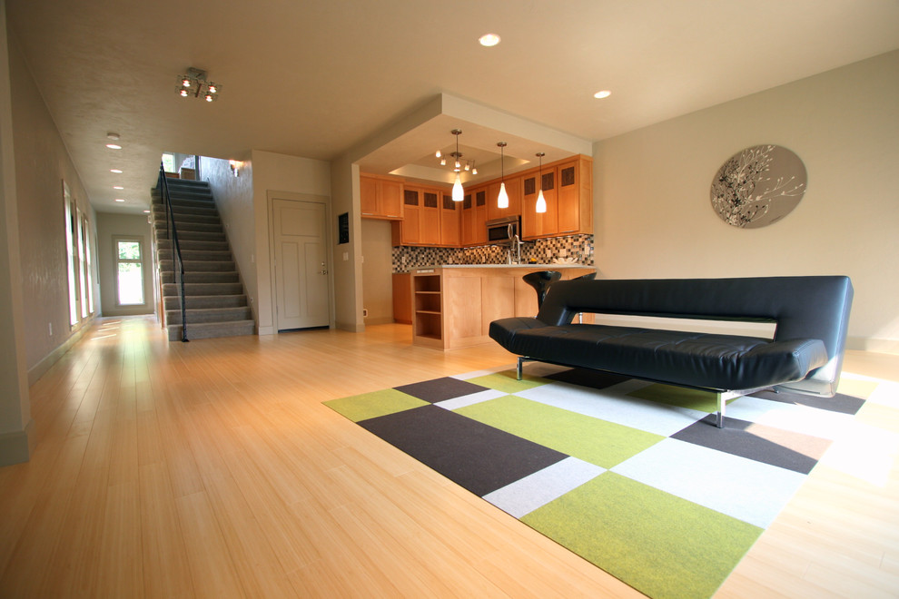 Mid-sized minimalist open concept bamboo floor family room photo in Portland with gray walls and no fireplace