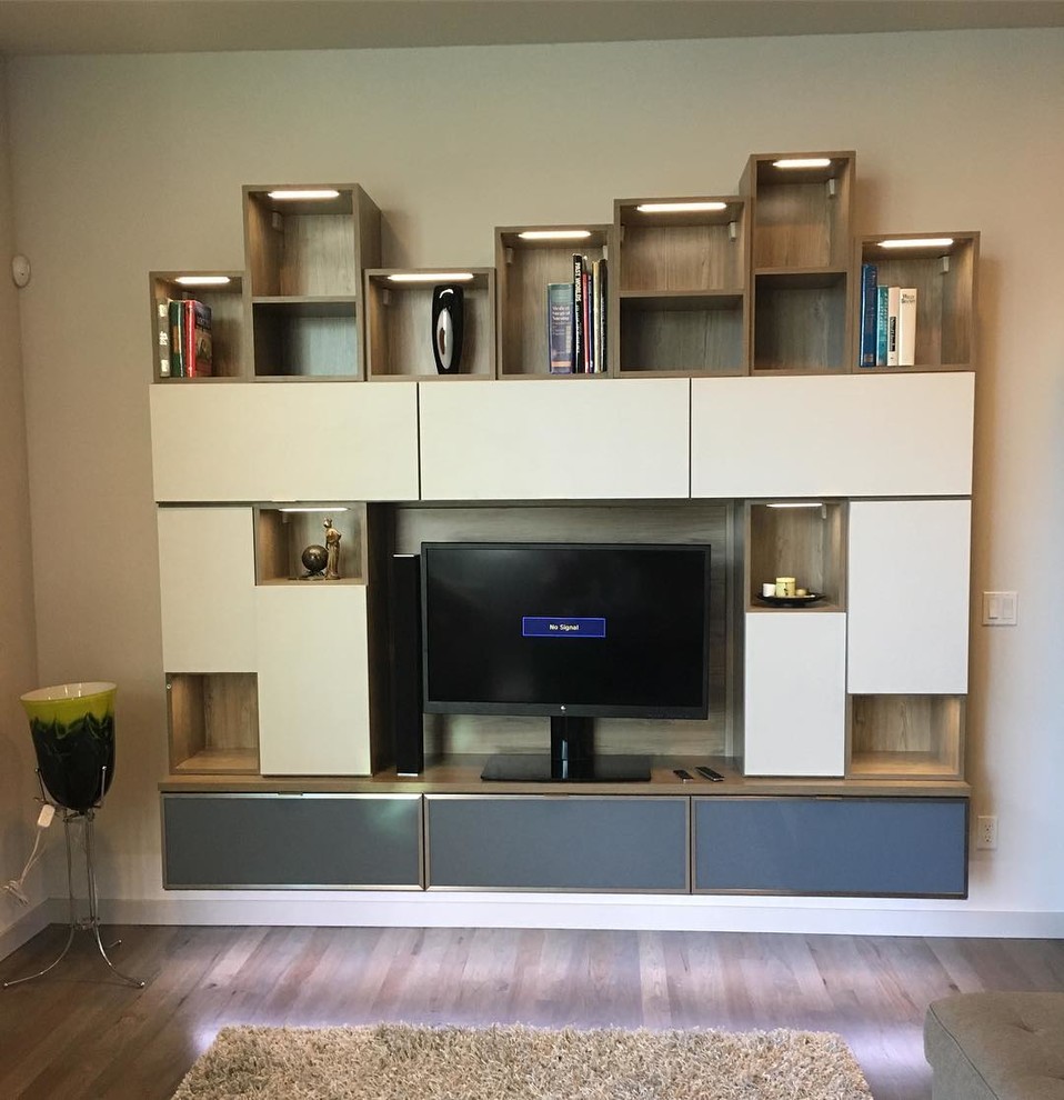Idee per un soggiorno minimalista di medie dimensioni con pareti beige, pavimento in legno massello medio e TV autoportante