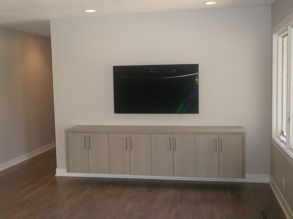 Photo of a modern games room in Other with grey walls, medium hardwood flooring and a wall mounted tv.