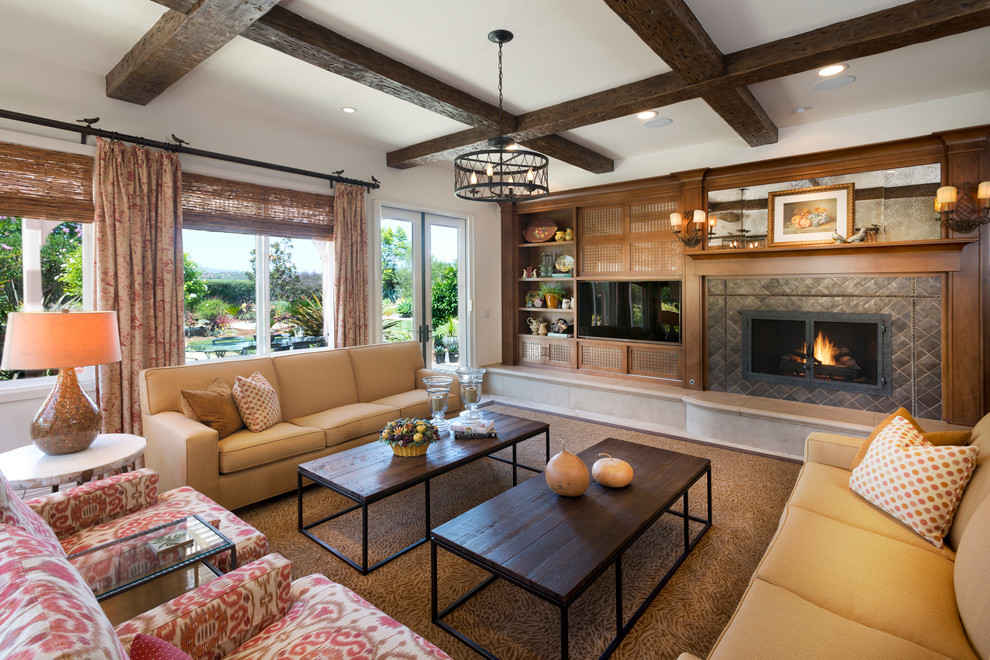 Inspiration for a large timeless open concept carpeted family room remodel in Los Angeles with beige walls, a standard fireplace, a tile fireplace and a media wall