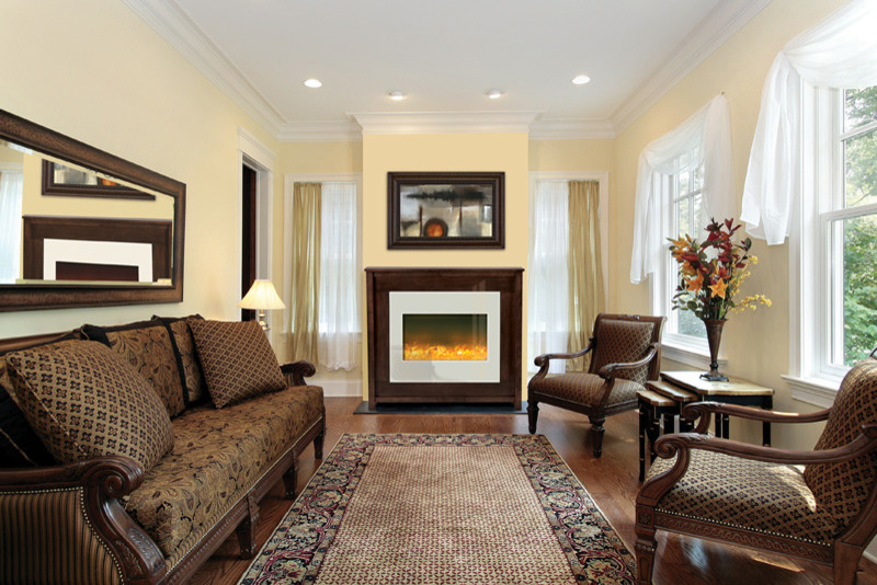 На фото: изолированная гостиная комната среднего размера в классическом стиле с желтыми стенами, паркетным полом среднего тона, стандартным камином, фасадом камина из дерева и коричневым полом