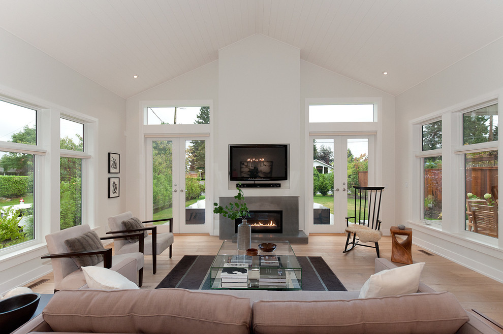 Example of a trendy light wood floor family room design in Vancouver with white walls, a ribbon fireplace and a wall-mounted tv