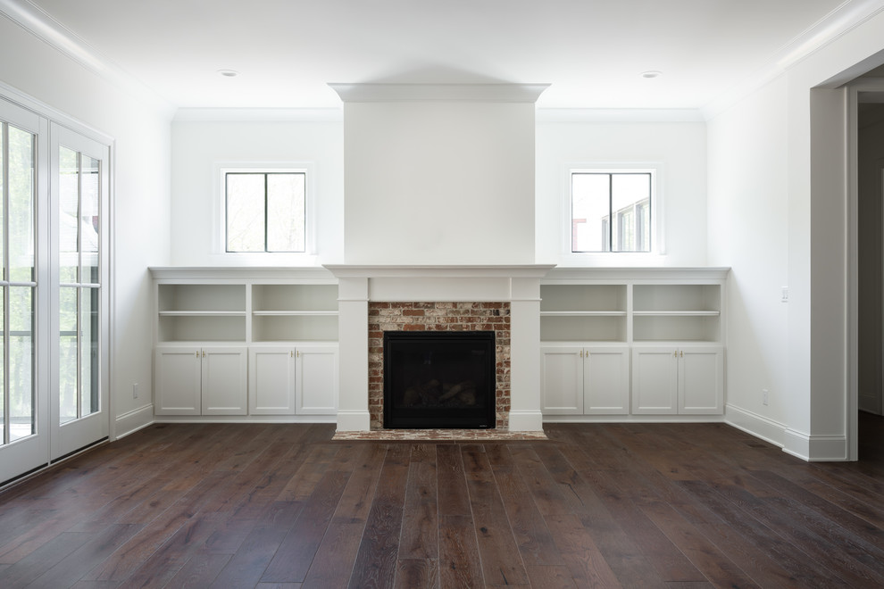 Example of a mid-sized transitional open concept medium tone wood floor and brown floor family room design in Louisville with white walls, a standard fireplace and a brick fireplace