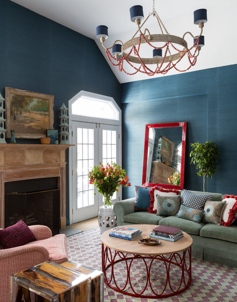 Réalisation d'une salle de séjour bohème de taille moyenne et ouverte avec un mur bleu, moquette, une cheminée standard, un manteau de cheminée en pierre et un téléviseur encastré.
