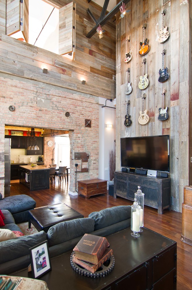 Example of an urban medium tone wood floor family room design in Chicago with a tv stand
