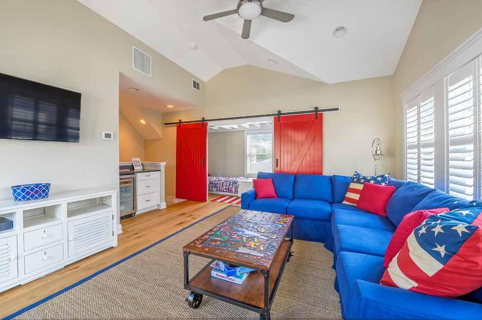 Beach style enclosed games room in Other with beige walls, medium hardwood flooring, no fireplace and a wall mounted tv.