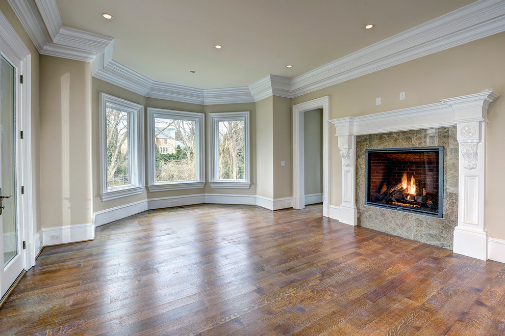Inspiration for a mid-sized modern open concept medium tone wood floor family room remodel in DC Metro with beige walls, a standard fireplace, a stone fireplace and no tv