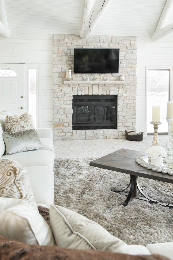 Family room - mid-sized transitional open concept carpeted and gray floor family room idea in Milwaukee with white walls, a standard fireplace, a stone fireplace and a wall-mounted tv