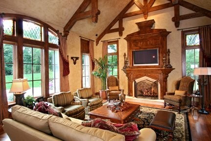 Foto di un grande soggiorno tradizionale aperto con pareti beige, pavimento in legno massello medio, camino classico e parete attrezzata